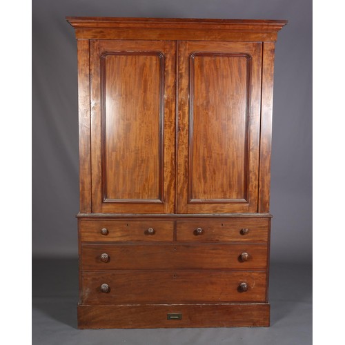 407 - A 19TH CENTURY MAHOGANY CLOTHES PRESS, having a moulded cornice above two indented panel doors, the ... 