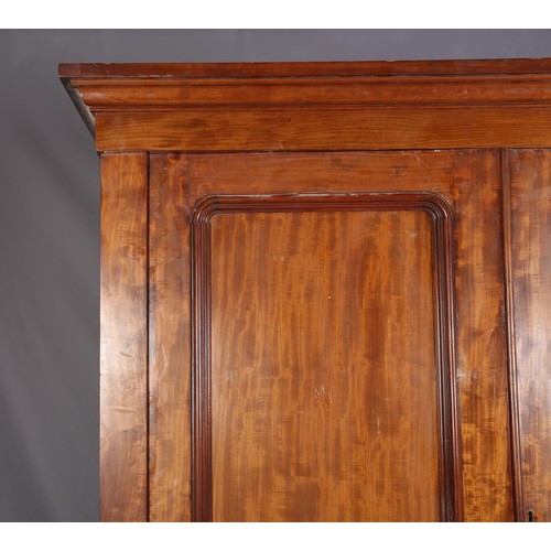 407 - A 19TH CENTURY MAHOGANY CLOTHES PRESS, having a moulded cornice above two indented panel doors, the ... 