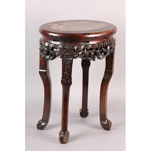 114 - A 19TH CENTURY CHINESE HARDWOOD AND MARBLE INSET URN STAND OF OVAL OUTLINE, the apron pierced and ca... 