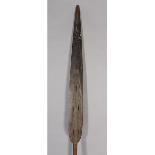 16 - A TRIBAL PADDLE with carved and pierced decoration, 181cm