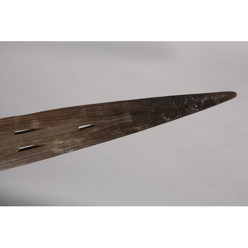 16 - A TRIBAL PADDLE with carved and pierced decoration, 181cm