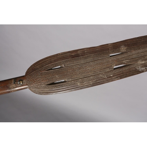 16 - A TRIBAL PADDLE with carved and pierced decoration, 181cm