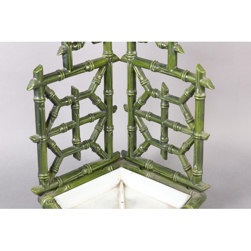 26 - AN AESTHETIC MOVEMENT CAST IRON STICK STAND, cast as bamboo, in pale green glaze with drip tray to b... 