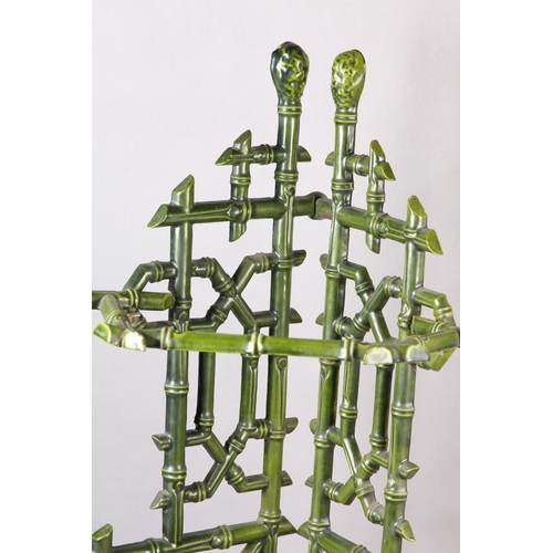 26 - AN AESTHETIC MOVEMENT CAST IRON STICK STAND, cast as bamboo, in pale green glaze with drip tray to b... 