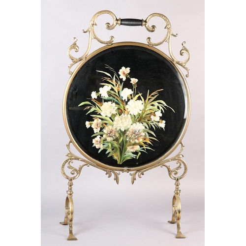 35 - A VICTORIAN BRASS FRAMED AND MIRROR FIRE SCREEN WITH TURNED EBONISED HANDLE, the glass painted with ... 