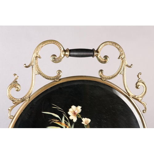 35 - A VICTORIAN BRASS FRAMED AND MIRROR FIRE SCREEN WITH TURNED EBONISED HANDLE, the glass painted with ... 