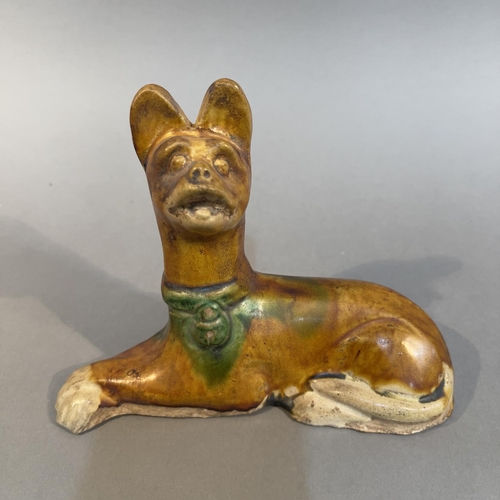 122 - A TANG-STYLE SANCAI GLAZED POTTERY FIGURE OF A RECUMBENT DOG, 18cm wide x 14cm high (Shipping catego... 