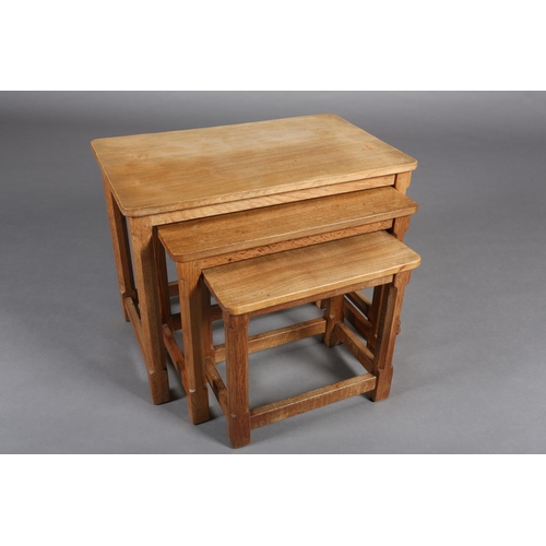 348 - THOMPSON OF KILBURN 'MOUSEMAN', A nest of three oak occasional tables on an octagonal and square fra... 