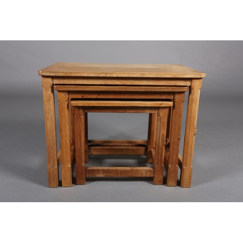 348 - THOMPSON OF KILBURN 'MOUSEMAN', A nest of three oak occasional tables on an octagonal and square fra... 