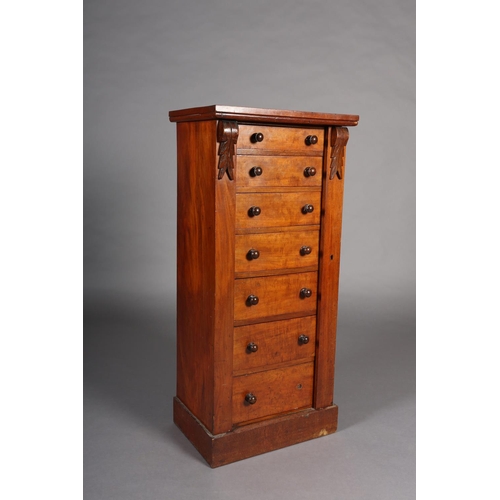 372 - A MID 19TH CENTURY MAHOGANY WELLINGTON CHEST of seven graduated drawers with turned handles, foliate... 