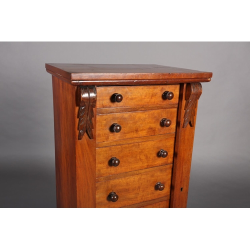 372 - A MID 19TH CENTURY MAHOGANY WELLINGTON CHEST of seven graduated drawers with turned handles, foliate... 