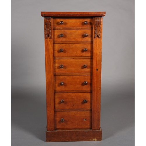 372 - A MID 19TH CENTURY MAHOGANY WELLINGTON CHEST of seven graduated drawers with turned handles, foliate... 