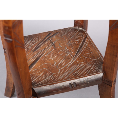 391 - AN AESTHETIC MOVEMENT POLISHED BEECH OCCASIONAL TABLE, in the Liberty style, all-over carved with ir... 