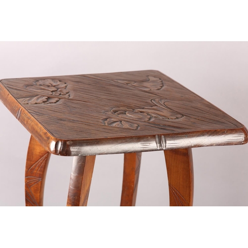 391 - AN AESTHETIC MOVEMENT POLISHED BEECH OCCASIONAL TABLE, in the Liberty style, all-over carved with ir... 