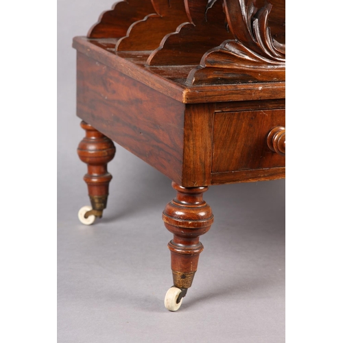 401 - A MID 19TH CENTURY WALNUT CANTERBURY of three divisions, pierced and carved with 'C' scrolls and lea... 