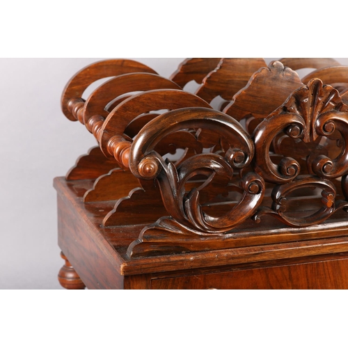 401 - A MID 19TH CENTURY WALNUT CANTERBURY of three divisions, pierced and carved with 'C' scrolls and lea... 