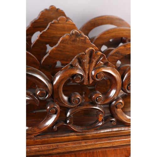 401 - A MID 19TH CENTURY WALNUT CANTERBURY of three divisions, pierced and carved with 'C' scrolls and lea... 