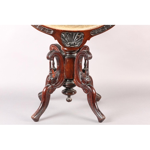 402 - A LATE 19TH CENTURY MAHOGANY REVOLVING PIANO STOOL, the dished seat with open curved upright arms, t... 