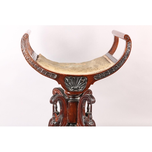 402 - A LATE 19TH CENTURY MAHOGANY REVOLVING PIANO STOOL, the dished seat with open curved upright arms, t... 