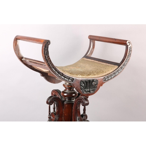 402 - A LATE 19TH CENTURY MAHOGANY REVOLVING PIANO STOOL, the dished seat with open curved upright arms, t... 