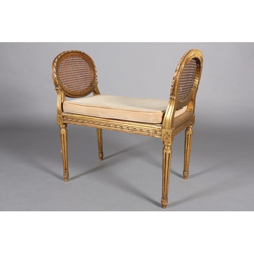 422 - A FRENCH GILT WOOD AND BERGERE CANED STOOL, having a carved riband encircling frame and twin raised ... 