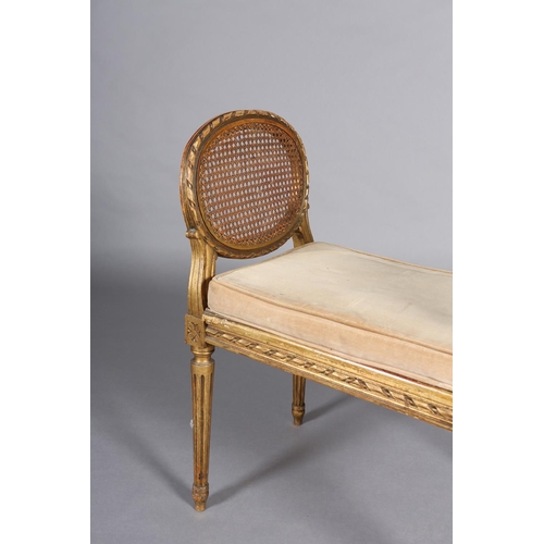 422 - A FRENCH GILT WOOD AND BERGERE CANED STOOL, having a carved riband encircling frame and twin raised ... 