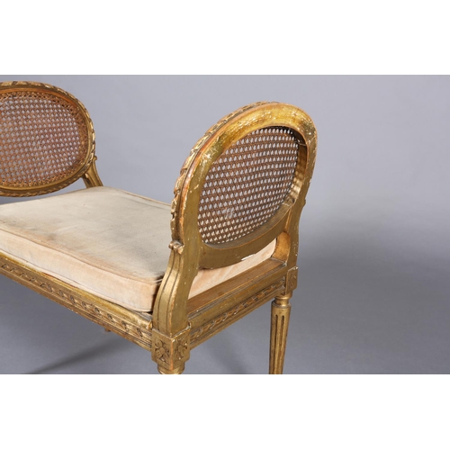 422 - A FRENCH GILT WOOD AND BERGERE CANED STOOL, having a carved riband encircling frame and twin raised ... 