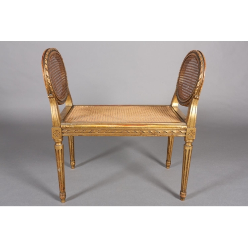 422 - A FRENCH GILT WOOD AND BERGERE CANED STOOL, having a carved riband encircling frame and twin raised ... 