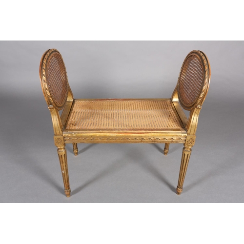 422 - A FRENCH GILT WOOD AND BERGERE CANED STOOL, having a carved riband encircling frame and twin raised ... 