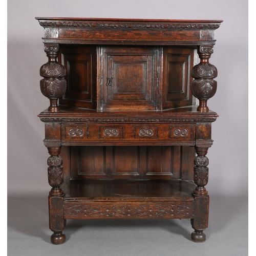 358 - A 17TH CENTURY JOINED OAK COURT CUPBOARD, having a foliate carved cornice, the frieze inlaid in ebon... 