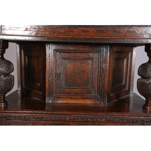 358 - A 17TH CENTURY JOINED OAK COURT CUPBOARD, having a foliate carved cornice, the frieze inlaid in ebon... 