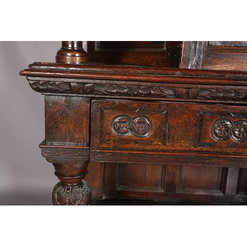 358 - A 17TH CENTURY JOINED OAK COURT CUPBOARD, having a foliate carved cornice, the frieze inlaid in ebon... 