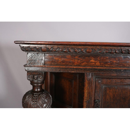 358 - A 17TH CENTURY JOINED OAK COURT CUPBOARD, having a foliate carved cornice, the frieze inlaid in ebon... 