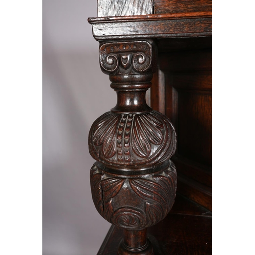 358 - A 17TH CENTURY JOINED OAK COURT CUPBOARD, having a foliate carved cornice, the frieze inlaid in ebon... 