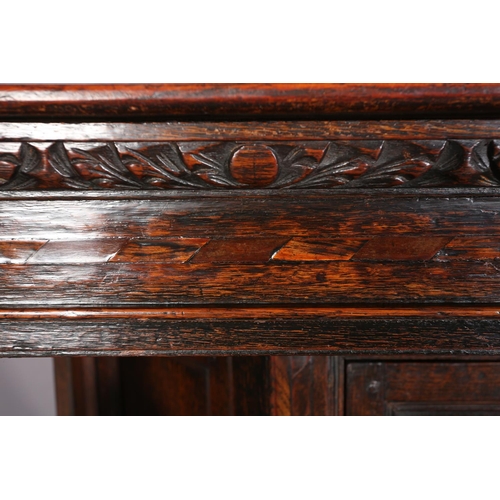 358 - A 17TH CENTURY JOINED OAK COURT CUPBOARD, having a foliate carved cornice, the frieze inlaid in ebon... 