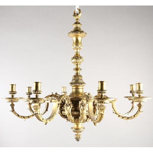 36 - A GILT METAL EIGHT LIGHT chandelier, the central baluster stem cast with scrolls and lion masks issu... 