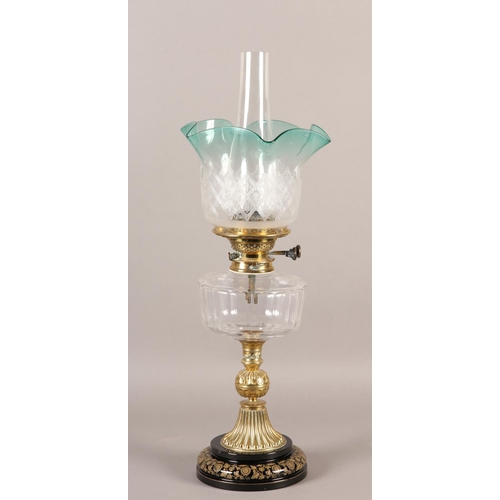 40B - A VICTORIAN BRASS OIL LAMP, having an etched and turquoise frilled shade, with a glass reservoir on ... 