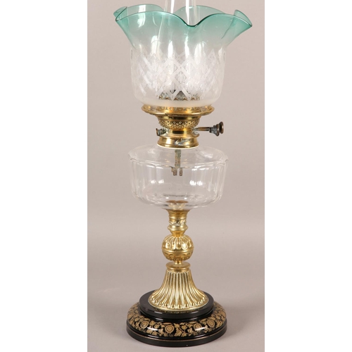 40B - A VICTORIAN BRASS OIL LAMP, having an etched and turquoise frilled shade, with a glass reservoir on ... 