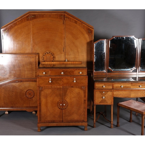 423 - AN ART DECO WALNUT, EBONY AND ROSEWOOD INLAID BEDROOM SUITE of radiating veneers centred with concen... 