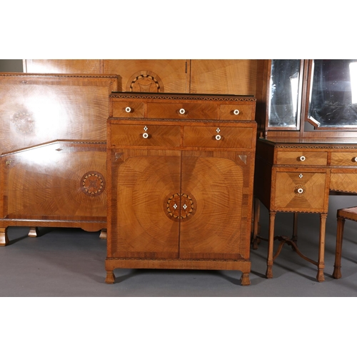 423 - AN ART DECO WALNUT, EBONY AND ROSEWOOD INLAID BEDROOM SUITE of radiating veneers centred with concen... 