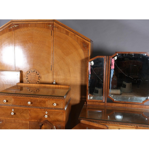 423 - AN ART DECO WALNUT, EBONY AND ROSEWOOD INLAID BEDROOM SUITE of radiating veneers centred with concen... 