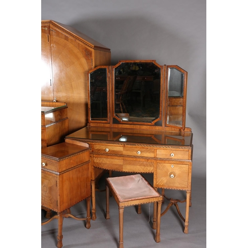 423 - AN ART DECO WALNUT, EBONY AND ROSEWOOD INLAID BEDROOM SUITE of radiating veneers centred with concen... 