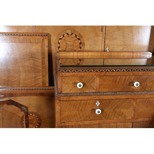 423 - AN ART DECO WALNUT, EBONY AND ROSEWOOD INLAID BEDROOM SUITE of radiating veneers centred with concen... 