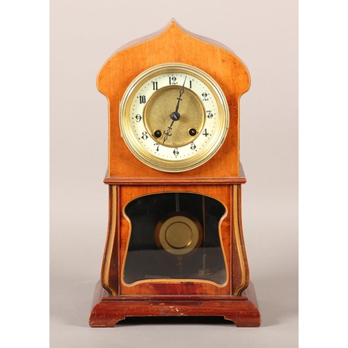 50 - AN ART NOUVEAU MAHOGANY AND GLAZED MANTEL CLOCK of arched outline, having a two part dial, black Ara... 