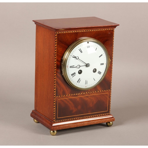 51 - AN EDWARD VII MAHOGANY MANTEL CLOCK INLAID WITH BOXWOOD AND EBONY STRINGING, having a French 8-day m... 