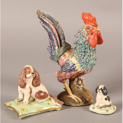 82 - A BASIL MATTHEW POTTERY MODEL OF A SPANIEL, sitting on a green and gilt cushion, 8cm high and anothe... 