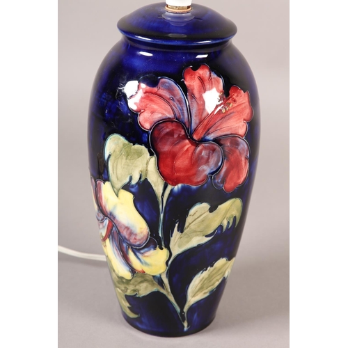 91 - A MOORCROFT LAMP, of baluster form, painted with yellow and purple hibiscus blooms and foliage, 35cm... 