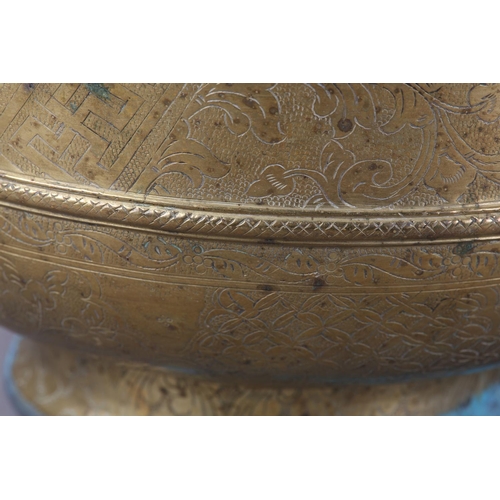 126 - A CHINESE BRASS BOWL, the annulated body engraved with reserves of peony and diaper cell on foot rim... 