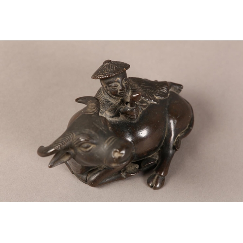 128 - A 19TH CENTURY CHINESE BRONZE GROUP OF A BOY LYING ON THE BACK OF A RECUMBENT WATER BUFFALO, 11cm wi... 