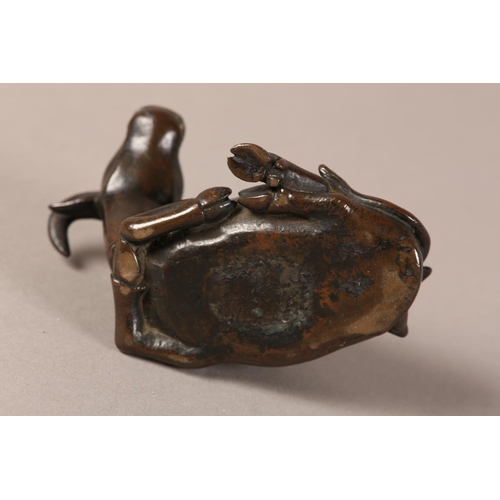 128 - A 19TH CENTURY CHINESE BRONZE GROUP OF A BOY LYING ON THE BACK OF A RECUMBENT WATER BUFFALO, 11cm wi... 